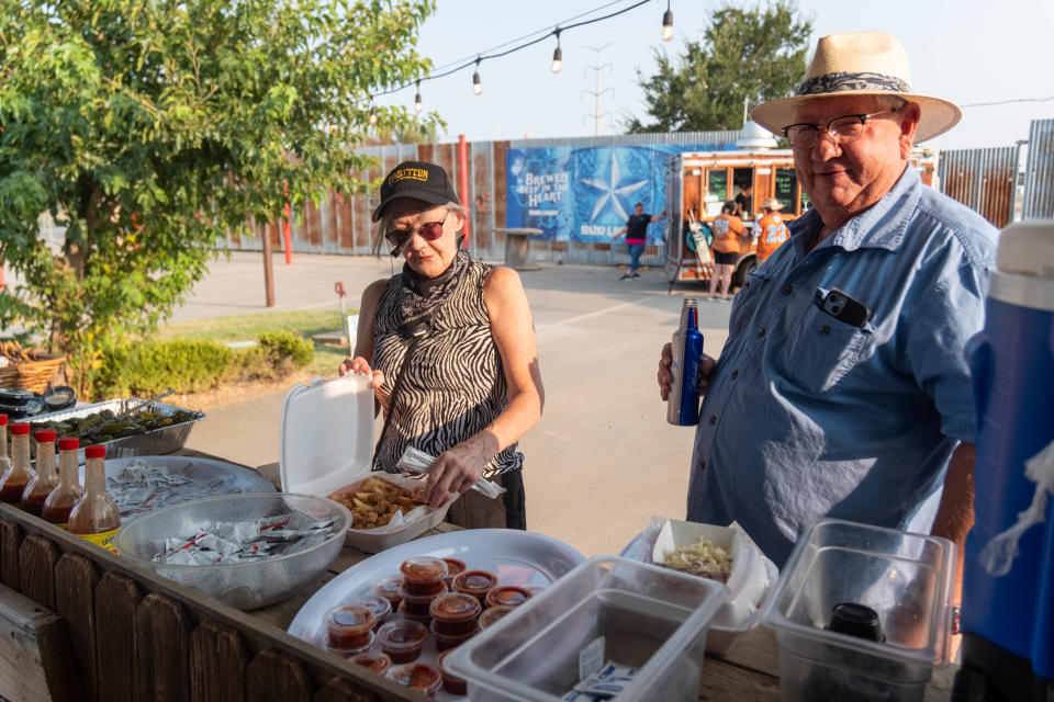 A couple get their orders of calf fries Saturday evening at the 1st annual Calf Fry Festival at the Starlight Ranch Event Center in Amarillo.
