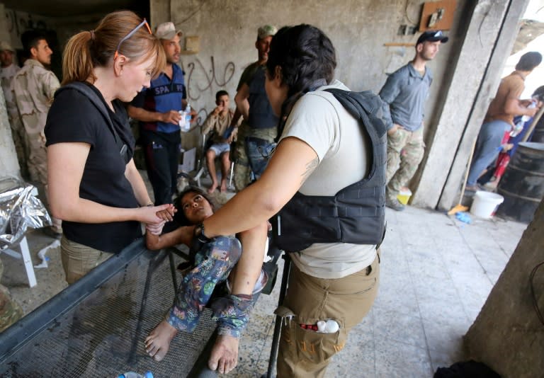 An Iraqi girl receives treatment at a makeshift hospital after a suicide attack as she was escaping the Old City of Mosul on June 23, 2017