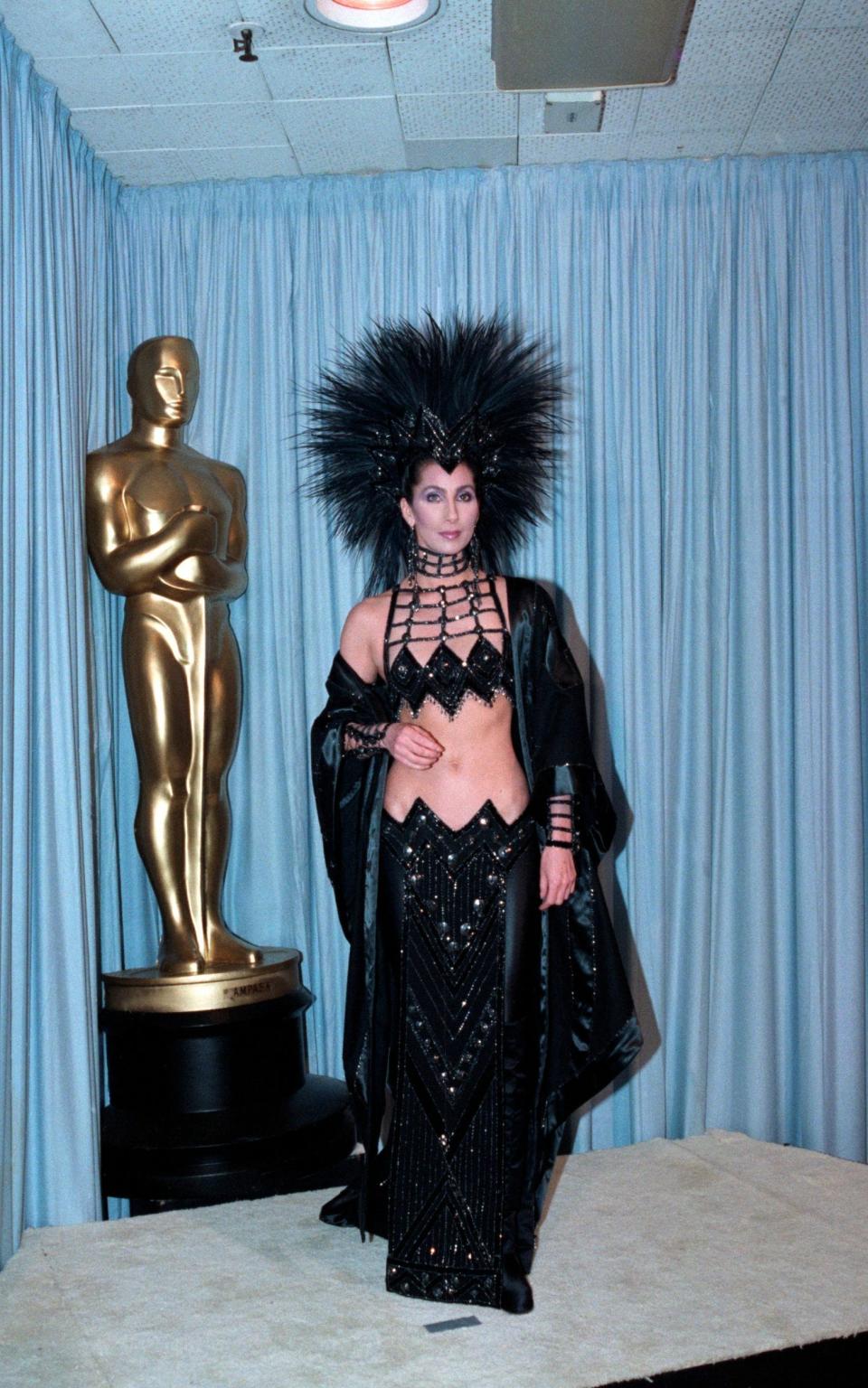 Kept: Cher still has her Bob Mackie feathered headdress and sequinned crop top from 1986 - Bettmann