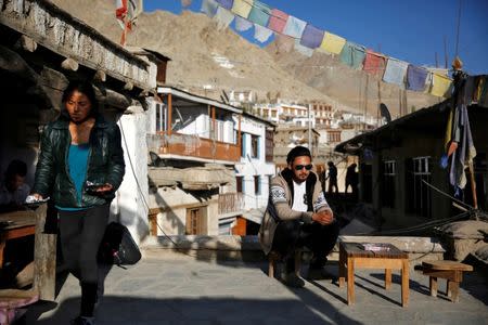 Travel agent, Stanton Othsil, 29, sits in the sun in Leh, the largest town in the region of Ladakh, nestled high in the Indian Himalayas, India September 29, 2016. When asked how living in the world's fastest growing major economy had affected life, Othsil said: "More tourists are coming now, especially Indians who are spending more money." REUTERS/Cathal McNaughton