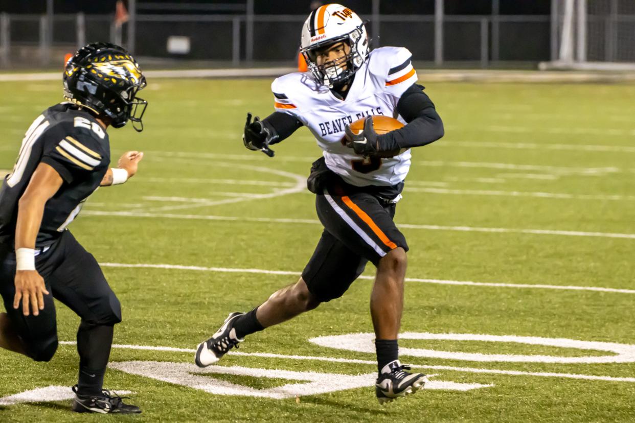 Da’Talian Beauford (3) tries to find the corner as DiMajio Locante (20) pursuits him in Beaver Falls’ first round matchup at Dormont Memorial Stadium Friday evening.