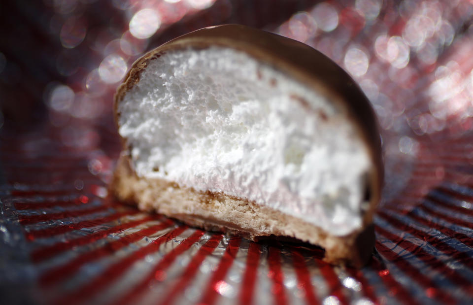 A Tunnock's Tea Cake is seen in Edinburgh, Scotland May 2, 2014. Started in 1890, Tunnock's is one of the oldest family firms in Scotland, their teacakes contain a puff marshmallow atop a biscuit covered in a layer of milk or dark chocolate. Scottish separatists are closing the gap on their unionist rivals as a September independence referendum draws nearer, according to a poll. But pollster TNS said it would still be a "major task" for them to draw level in time. In a poll of 995 adults, TNS found that support for the pro-independence campaign had grown by two points to 32 percent compared with last month, while the campaign to reject independence had slipped back a point to 41 percent. In the run-up to the vote, Reuters photographer Suzanne Plunkett took a series of close-up pictures of food, drink and various objects typically associated with Scotland. Picture taken May 2, 2014. REUTERS/Suzanne Plunkett  (BRITAIN - Tags: POLITICS FOOD SOCIETY)    ATTENTION EDITORS: PICTURE 06 OF 28 FOR PACKAGE 'DETAILS OF SCOTLAND'  TO FIND ALL IMAGES SEARCH 'PLUNKETT DETAIL'