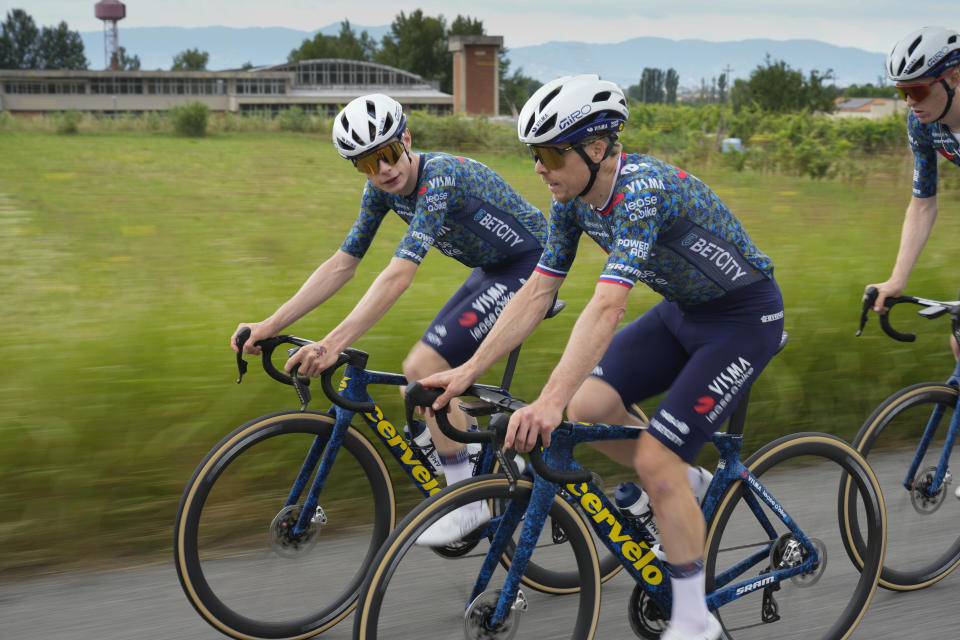 Denmark's Jonas Vingegaard, left, and Slovenia's Jan Tratnik, center, and other Visma-Lease a Bike fellow team riders went for training near Florence, Italy, Thursday, June 27, 2024, two days before the start of the Tour de France cycling race. (AP Photo/Jerome Delay)