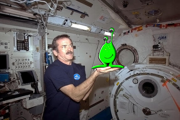 Chris Hadfield's grand April Fools' Day finale shows him posing with an alien that just stopped by the station to say hi.