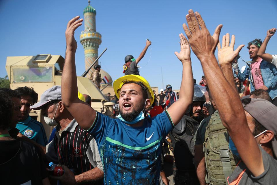 Anti-government protesters try to cross the al- Shuhada (Martyrs) bridge in central Baghdad, Iraq, Wednesday, Nov. 6, 2019. The rallies that have gripped in Iraq and similar demonstrations underway in Lebanon pose a threat to some of Iran's main regional allies as Tehran faces mounting pressure from U.S. sanctions. (AP Photo/Hadi Mizban)