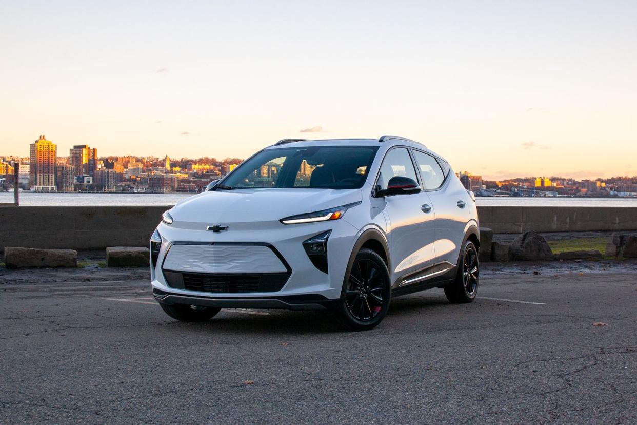 2023 chevrolet bolt euv premiere redline parked at sunset near city skyline