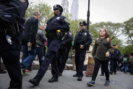 FILE PHOTO: Climate change activist Zayne Cowie walks on the Brooklyn Bridge during a youth climate march in New York City, U.S., May 3, 2019. REUTERS/Brendan McDermid
