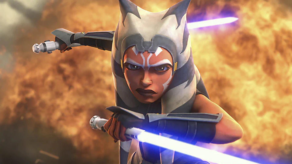 Ahsoka wields lightsabers in front of an explosion