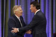 Democratic gubernatorial candidate former Governor Terry McAuliffe, left, greets Republican challenger, Glenn Youngkin, at the start of a debate at the Appalachian School of Law in Grundy, Va., Thursday, Sept. 16, 2021. (AP Photo/Steve Helber)