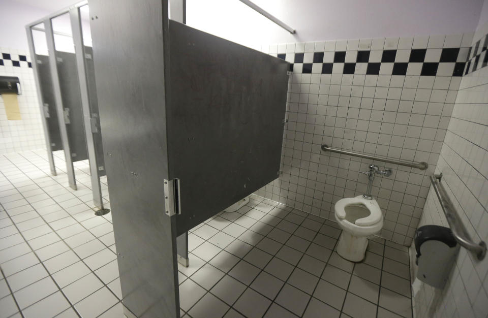 A disabled toilet stall is shown in the boys bathroom where police were investigating reports of a brutal assault of a transgender teen at the Hercules Middle-High School campus in Hercules, Calif., Tuesday, March 4, 2014. The 15-year-old student told officers he was leaving a boy's bathroom at Hercules High School on Monday when three teenage boys pushed him inside a handicapped stall and physically and sexually assaulted him, Hercules police Detective Connie Van Putten said. (AP Photo/Jeff Chiu)