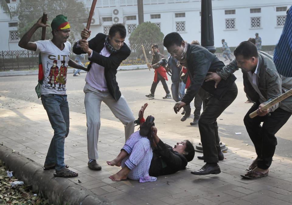 FILE- Supporters of the ruling Bangladesh Awami League beat a lawyer and supporter of the main opposition Bangladesh Nationalist Party (BNP) during a protest by opposition activists in Dhaka, Bangladesh, Dec. 29, 2013. BNP is boycotting the Jan. 7 polls, saying the government cannot ensure a fair vote, and setting the stage for Prime Minister Sheikh Hasina to secure her fourth consecutive and fifth overall term in office. (AP Photo/A.M. Ahad, File)