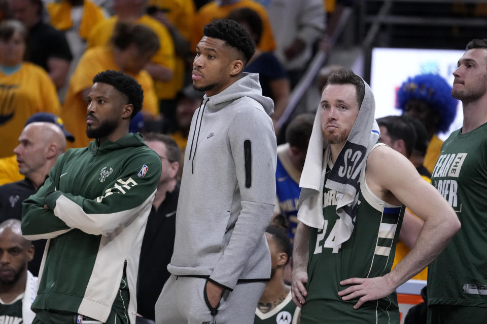 Milwaukee Bucks forward Giannis Antetokounmpo, center, and guard Pat Connaughton (24) watch from the bench during the second half against the Indiana Pacers in Game 6 in an NBA basketball first-round playoff series, Thursday, May 2, 2024, in Indianapolis. (AP Photo/Michael Conroy)