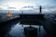 Sergii Rodionov takes a photograph on his mobile phone from a rooftop in Moscow, Russia, June 2, 2017. REUTERS/Maxim Shemetov