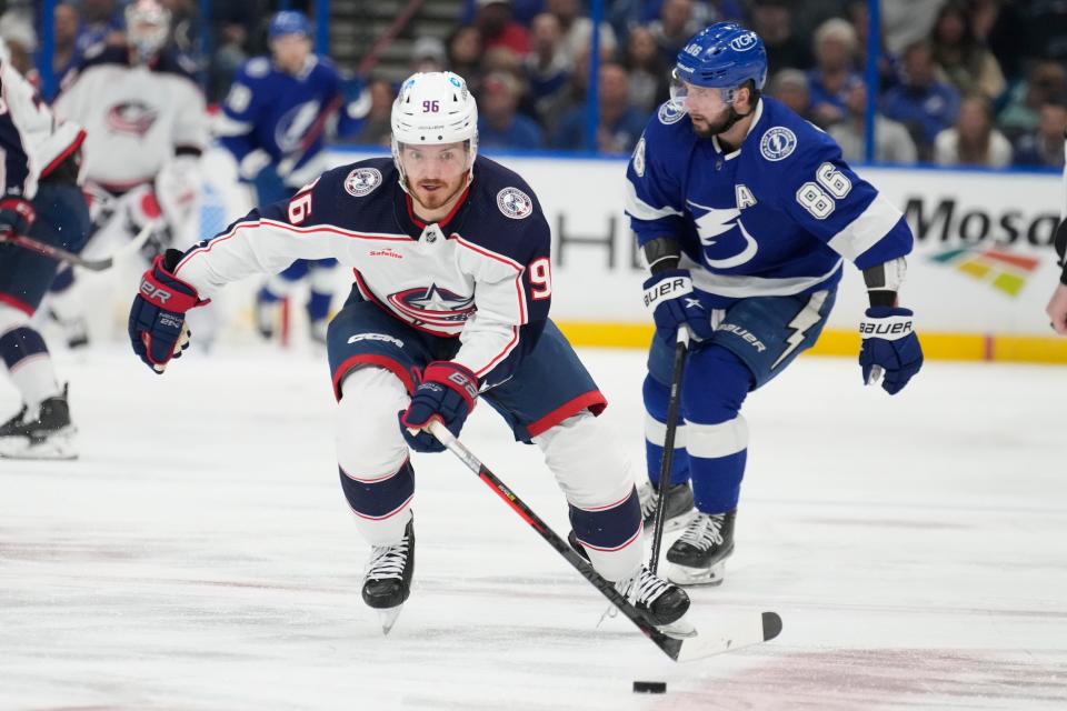 Columbus Blue Jackets center Jack Roslovic (96) breaks out ahead of Tampa Bay Lightning right wing Nikita Kucherov (86) during the first period of an NHL hockey game Tuesday, Jan. 10, 2023, in Tampa, Fla. (AP Photo/Chris O'Meara)