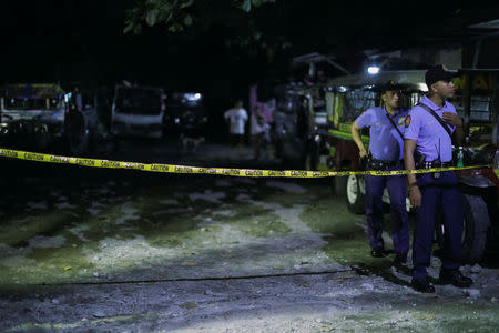 Policemen stand behind a police line after a man was killed during a police anti-drug operation in Caloocan city, Metro Manila, Philippines August 17, 2017. REUTERS/Erik De Castro