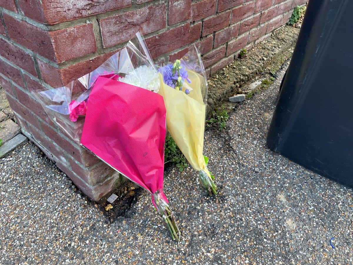 Flowers left at the scene in The Row in Sutton, near Ely, Cambridgeshire (PA)