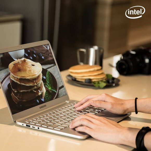 Person working on a laptop featuring a photo of a stack of pancakes