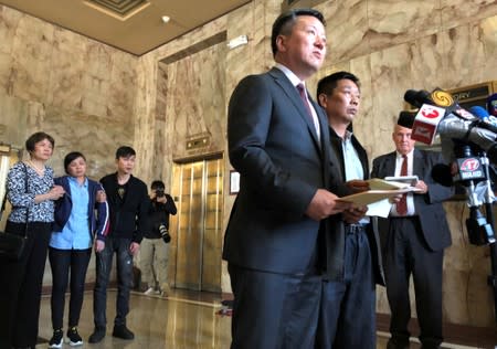 Zhidong Wang, attorney and spokesman for the Zhang family speaks to reporters in Peoria, Illinois