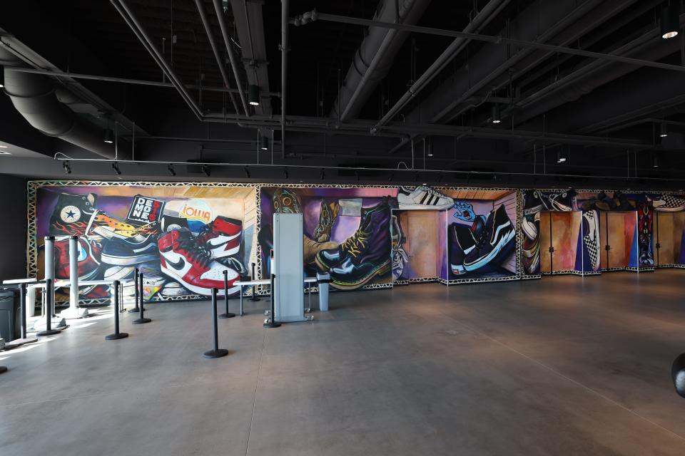 Des Moines artist James Navarro created this mural that depicts footwear such as heels and cowboy boots.