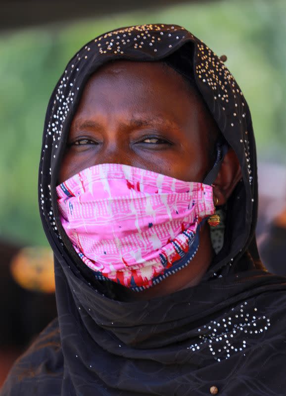 A woman wearing an hijab poses for a picture with a fabric face mask on, following the spread of the coronavirus disease (COVID-19) in Abuja