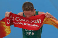 Triathlon - Gold Coast 2018 Commonwealth Games - Men's Final - Southport Broadwater Parklands - Gold Coast, Australia - April 5, 2018 - Henri Schoeman of South Africa kisses the finish line ribbon after winning the event. REUTERS/Athit Perawongmetha