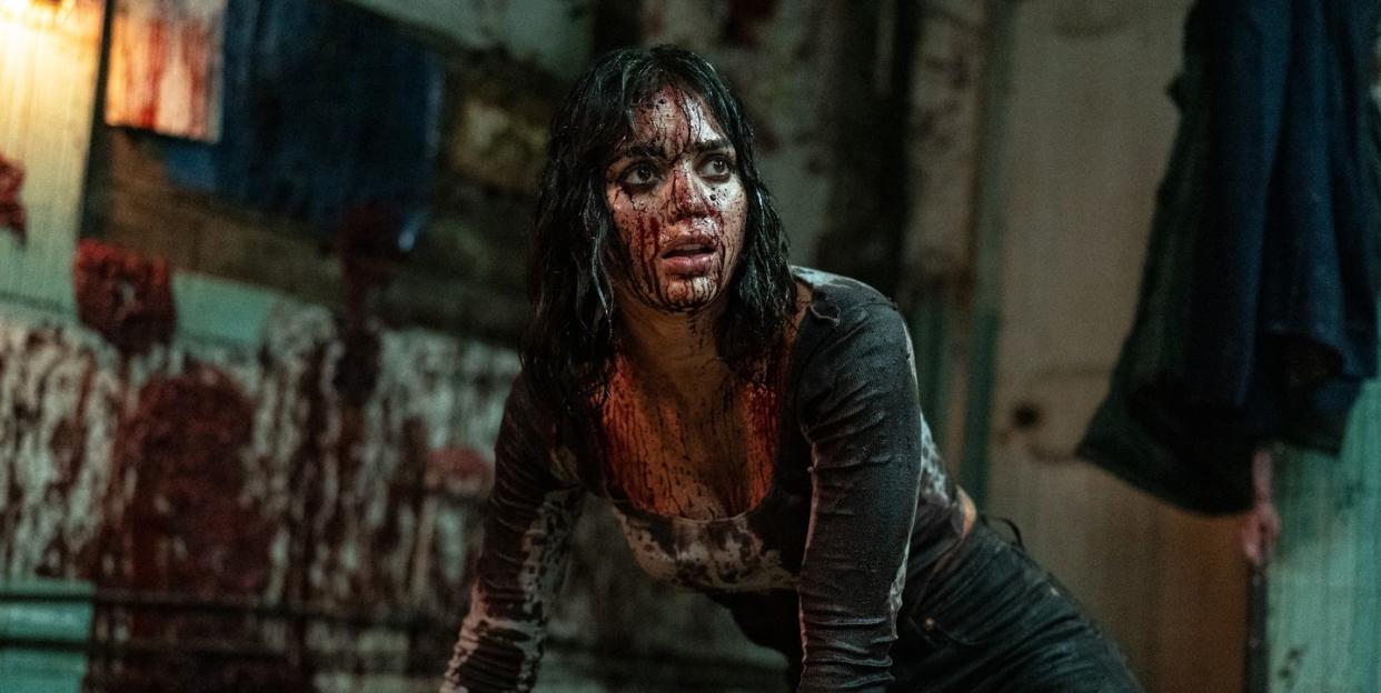 melissa barrera as joey covered in blood in abigail movie