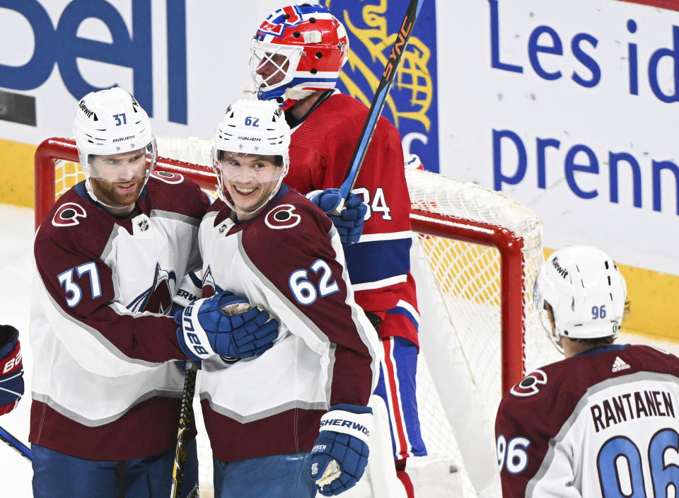 Colorado Avalanche's Artturi Lehkonen (62) celebrates with teammate J.T. Compher (37) after scoring against the Montreal Canadiens goaltender Jake Allen during the first period of an NHL hockey game in Montreal, Monday, March 13, 2023. (Graham Hughes/The Canadian Press via AP)