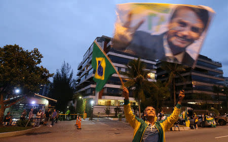 A supporter of Brazilian presidential candidate Jair Bolsonaro is seen in front of Bolsonaro's condominium at Barra da Tijuca neighborhood in Rio de Janeiro, Brazil October 5, 2018. REUTERS/Sergio Moraes