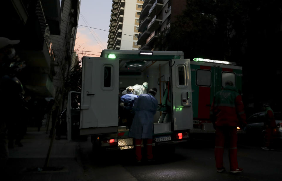 FILE - In this May 7, 2020 file photo, health workers evacuate an elderly person from a nursing home after residents at the facility tested positive for the new coronavirus in Buenos Aires, Argentina. Argentina reached 1 million confirmed coronavirus cases on Monday, Oct. 19, 2020, according to the Ministry of Health. (AP Photo/Natacha Pisarenko, File)