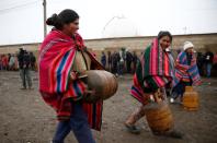 Women carry gas cylinders near petrol plant of Senkata, that normalizes fuel distribution in El Alto outskirts of La Paz