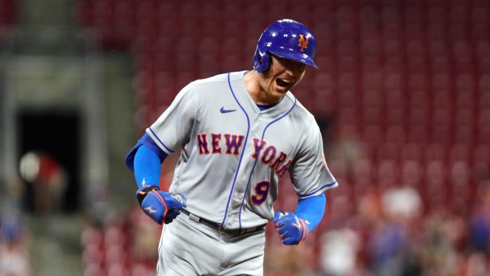 New York Mets center fielder Brandon Nimmo (9) reacts as he runs the bases after hitting a three-home run against the Cincinnati Reds in the tenth inning at Great American Ball Park.