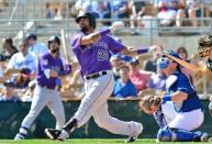 Feb 28, 2019; Phoenix, AZ, USA; Colorado Rockies first baseman Ian Desmond (20) hits a solo home run during the third inning against the Los Angeles Dodgers at Camelback Ranch. Mandatory Credit: Matt Kartozian-USA TODAY Sports