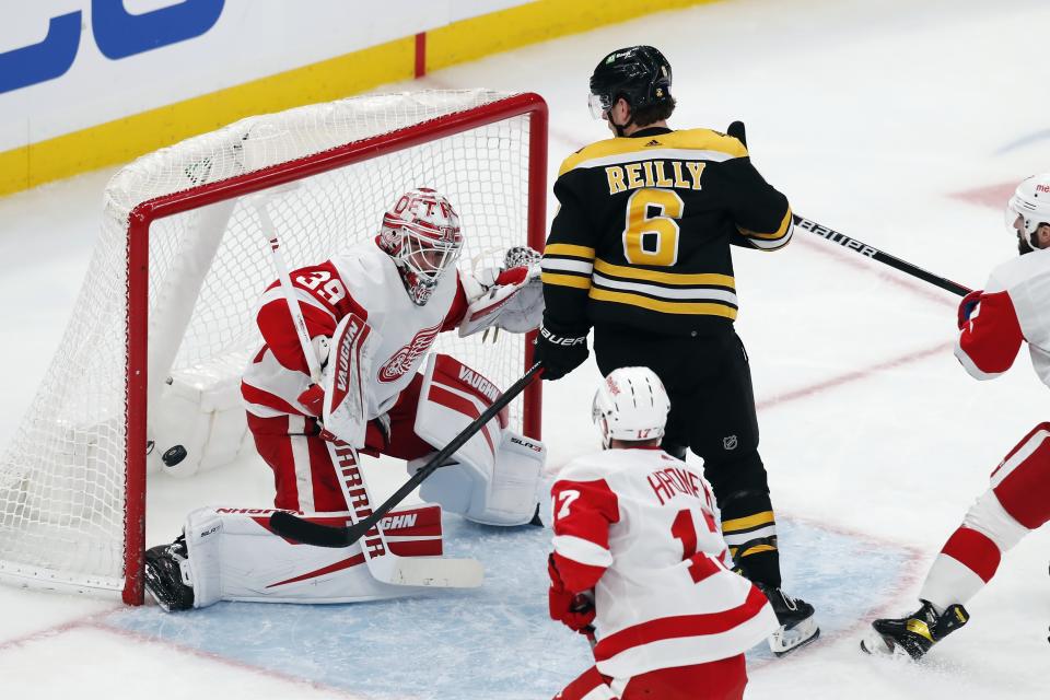 Detroit Red Wings' Alex Nedeljkovic (39) blocks a shot by Boston Bruins' Mike Reilly (6) during the second period of an NHL hockey game Tuesday, Nov. 30, 2021, in Boston. (AP Photo/Michael Dwyer)