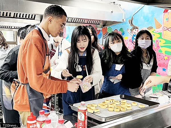 新莊高中學生與美國奧勒岡主教學校學生（左1）進行台灣美食鳳梨酥的製作。（圖：新北市教育局提供）