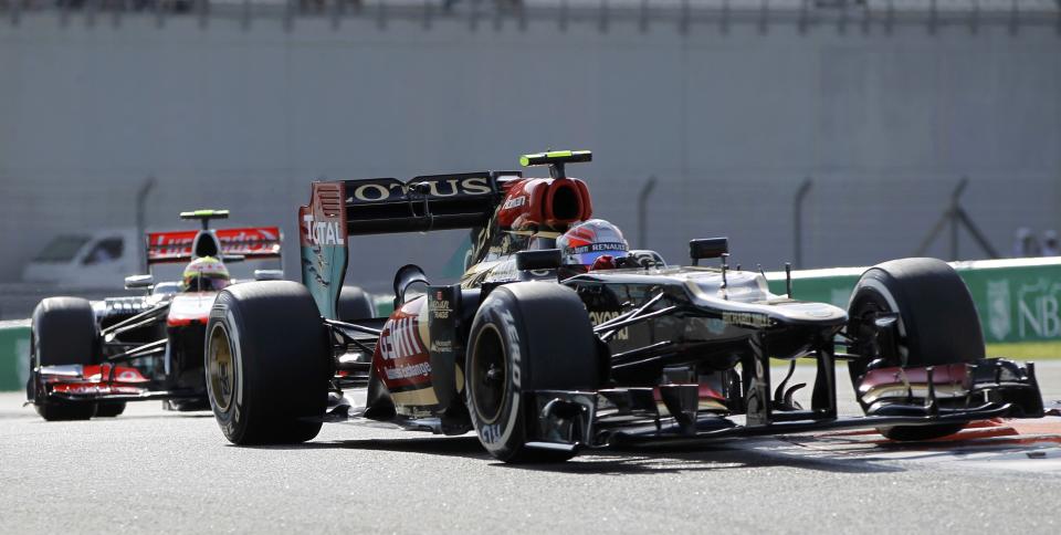 Lotus F1 Formula One driver Romain Grosjean of France (front) drives ahead of McLaren Formula One driver Sergio Perez of Mexico during the third practice session of the Abu Dhabi F1 Grand Prix at the Yas Marina circuit on Yas Island, November 2, 2013. REUTERS/Caren Firouz (UNITED ARAB EMIRATES - Tags: SPORT MOTORSPORT F1)