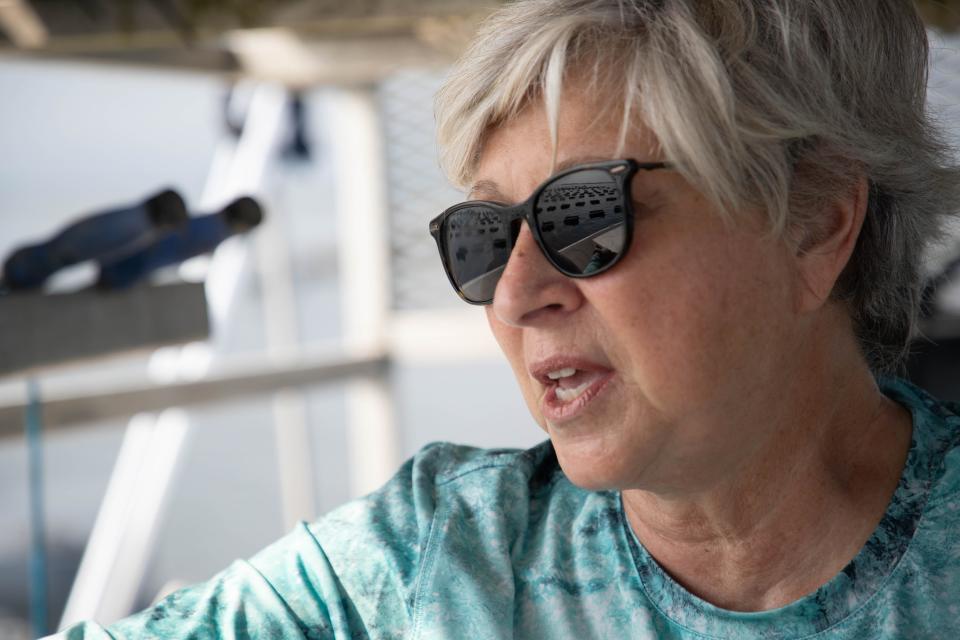OysterMom Deborah Keller's lease in Oyster Bay is reflected in her sunglasses as she stands on her boat Wednesday, June 16, 2021.