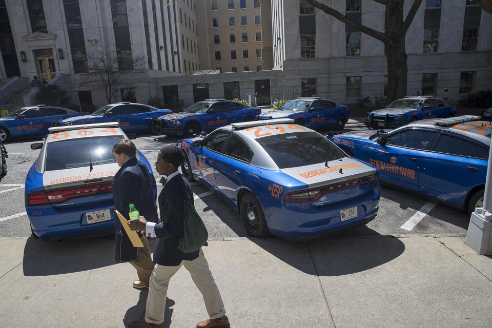 A line of Georgia State Trooper vehicles sit outside of the Georgia State Capitol building as members of the Senate debate HB 481 on the 35th legislative day at the Georgia State Capitol building in downtown Atlanta, Friday, March 22, 2019. (Alyssa Pointer/Atlanta Journal-Constitution via AP)