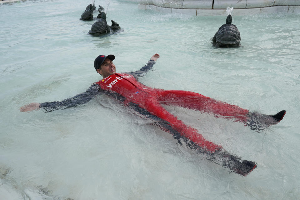 Will Power celebrates in the fountain after winning the IndyCar Detroit Grand Prix auto race on Belle Isle in Detroit, Sunday, June 5, 2022. (AP Photo/Paul Sancya)