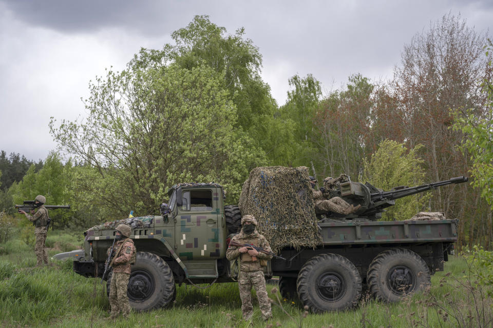 Members of a Ukrainian air-defense unit demonstrate their work near Kyiv on Monday, May 8, 2023. From camouflaged positions, the units dart out by truck into the farm fields around the capital, ready to take down enemy drones or missiles. Since Russia resumed regular air attacks on April 28, the units have a perfect score, intercepting every drone and missile shot at the capital. (AP Photo/Andrew Kravchenko)