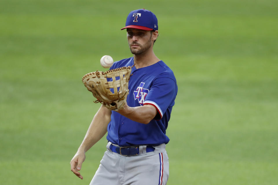 Texas Rangers infielder Greg Bird tosses a ball in his glove in an intrasquad game during baseball practice at Globe Life Field in Arlington, Texas, Friday, July 10, 2020. (AP Photo/Tony Gutierrez)