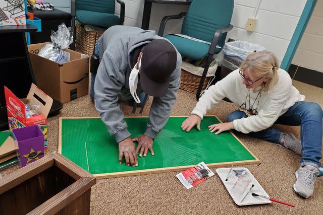 <p>Courtesy Regina Passwaters</p> Four Seasons Elementary chief custodian Louis Queen (L) at work