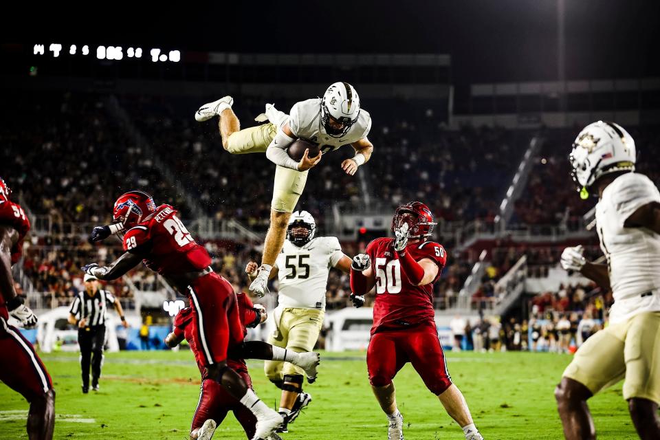 John Rhys Plumlee (10) soars across the goal line for a second-quarter touchdown run against Florida Atlantic.