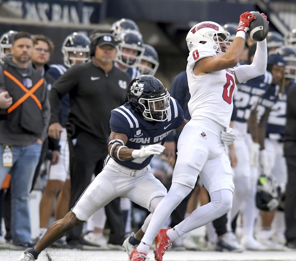 Fresno State wide receiver Mac Dalena (0) catches a pass as Utah State cornerback Xavion Steele defends during the first half of an NCAA college football game Friday, Oct. 13, 2023, in Logan, Utah. | Eli Lucero/The Herald Journal via AP
