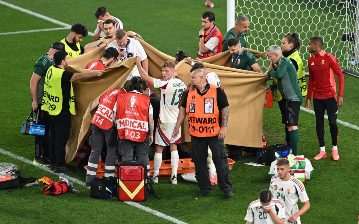Hungary's Barnabas Varga receives medical attention after sustaining an injury