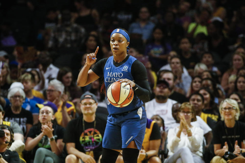 Odyssey Sims with a finger raised and the ball at a basketball game.