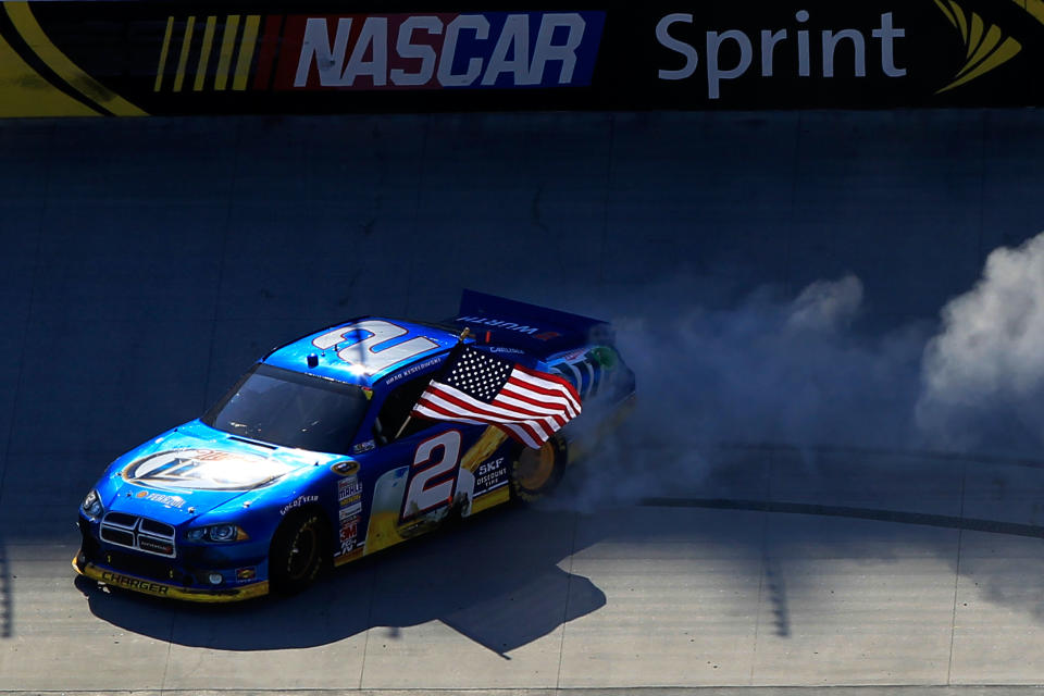 BRISTOL, TN - MARCH 18: Brad Keselowski, driver of the #2 Miller Lite Dodge, and crew members celebrate with the American Flag and a burnout after winning the NASCAR Sprint Cup Series Food City 500 at Bristol Motor Speedway on March 18, 2012 in Bristol, Tennessee. (Photo by Chris Trotman/Getty Images)