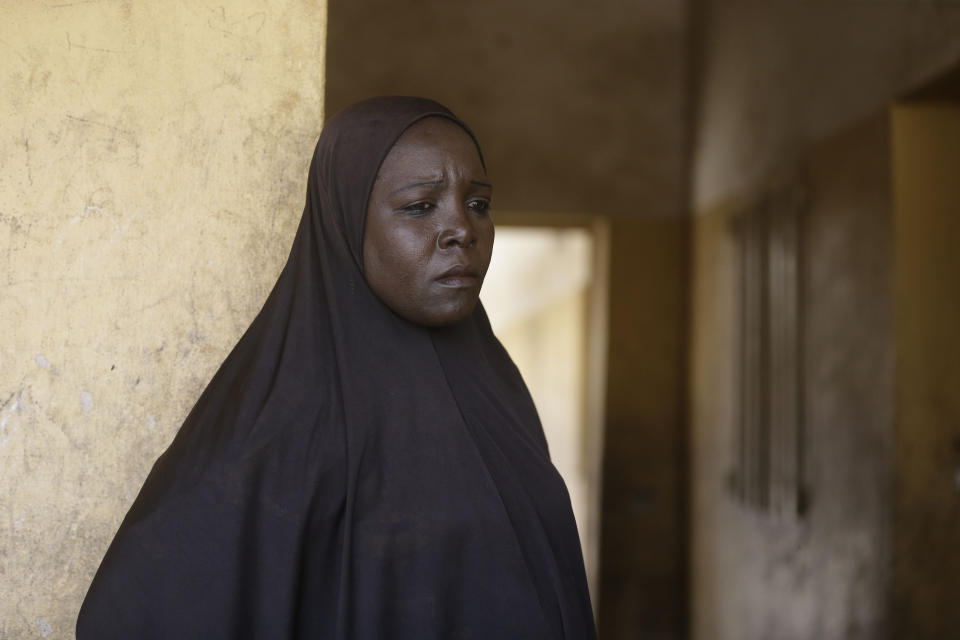 In this photo taken on Thursday, Feb. 21, 2019, Mariam Musa, 32-year-old, a woman displaced by Islamist extremist stand outside the entrance to her room at Malkohi camp in Yola, Nigeria. Mariam Musa says in the makeshift camp for Nigerians who have fled Boko Haram violence, the upcoming presidential vote isn’t a topic of conversation, because nearly all are more worried about putting food on the table. (AP Photo/ Sunday Alamba)