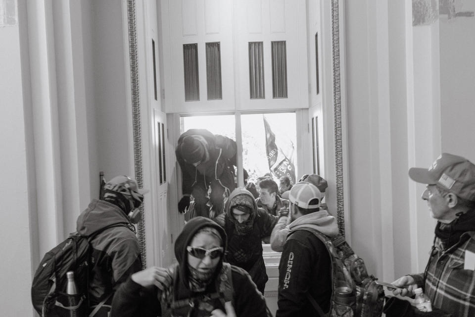 Pro-Trump rioters enter the Capitol through a broken window.<span class="copyright">Christopher Lee for TIME</span>