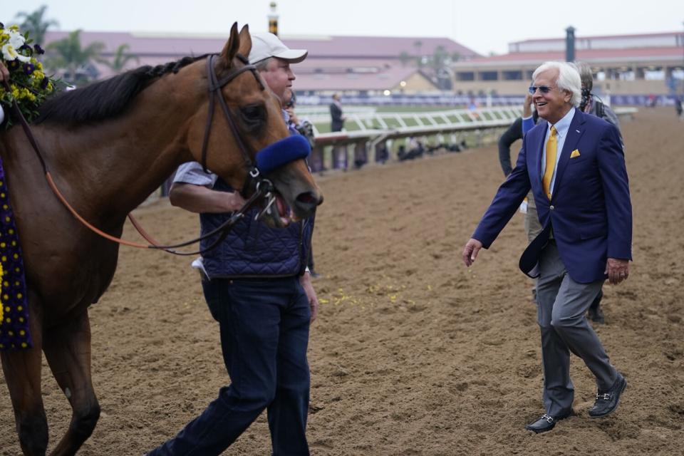 Trainer Bob Baffert, right, walks up to Mike Smith on Corniche.