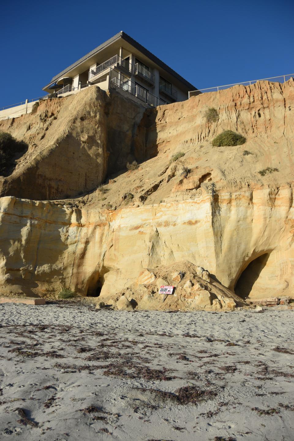 A building in San Diego County, with rubble from a bluff collapse on the beach below in August 2022.